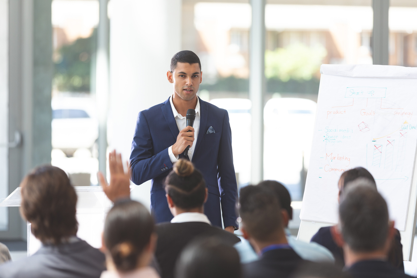 Male speaker speaking with microphone at conference